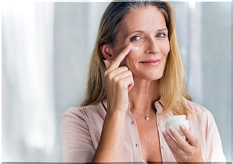 Woman creams her face