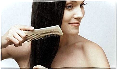 Woman combs hair to prevent hair loss