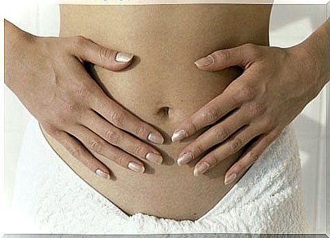 Woman holds her stomach