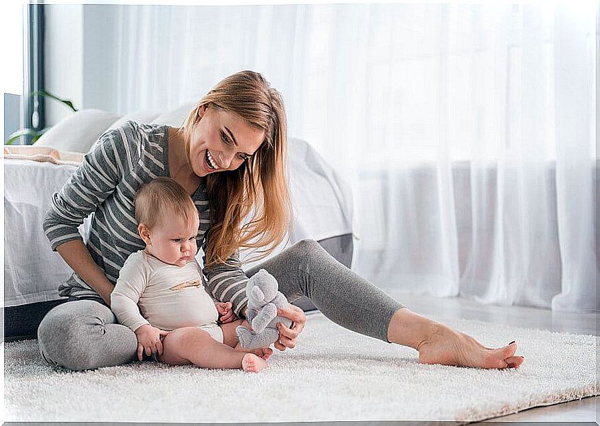 Mother and child sit on the floor