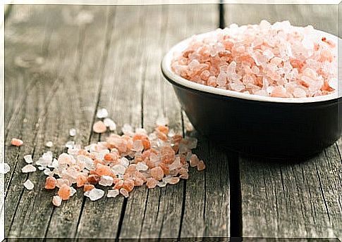 Coarse pink and white salt crystals as part of a peeling against calluses on the feet.