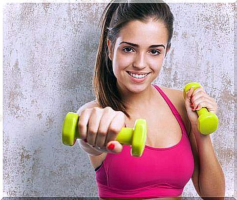 Woman lifts weights to tighten her breasts