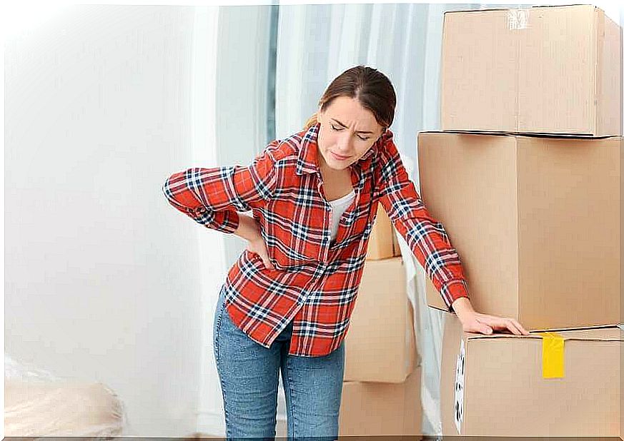 Woman lifts heavy boxes