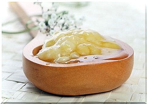 Banana mash on a wooden spoon.